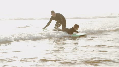 Father-teaching-son-swimming-on-board