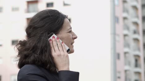 Serious-businesswoman-talking-by-cell-phone