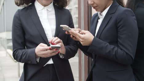 Serious-businesswomen-using-smartphones