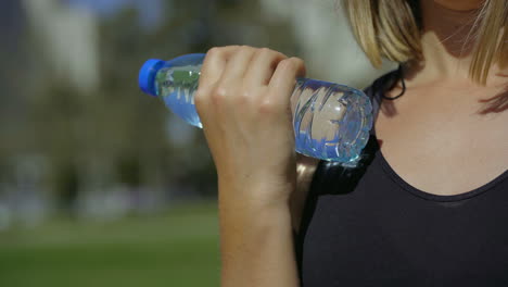 Cropped-shot-of-young-woman-training-with-bottle-of-water.