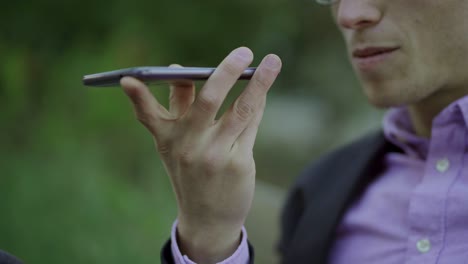 Cropped-shot-of-young-man-talking-on-smartphone