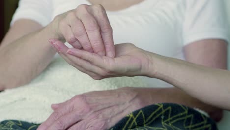Close-up-shot-of-female-hands,-one-giving-pills-to-another