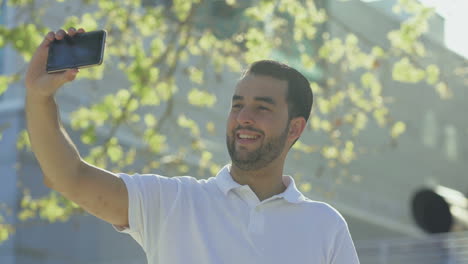 Smiling-bearded-man-taking-selfie-with-smartphone.