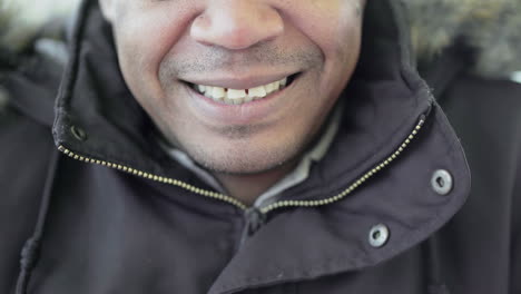 Close-up-shot-of-Afro-American-middle-aged-mans-mouth-biting-lips-slightly-and-smiling
