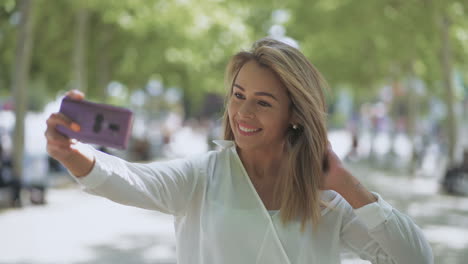 Happy-young-woman-taking-selfie-outdoor