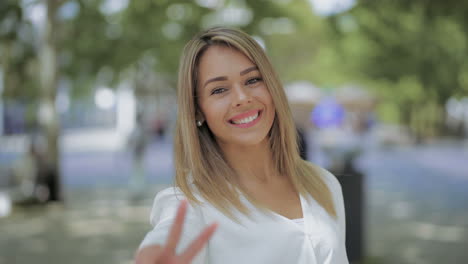 Girl-waving-hand-and-smiling-at-camera