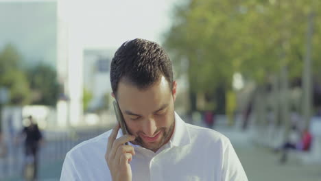 Successful-young-businessman-talking-on-phone-outdoor.