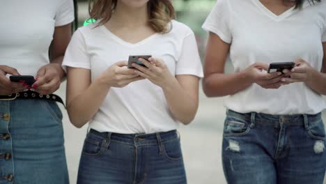 Cropped-shot-of-friends-holding-modern-phones