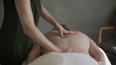 Massage-practitioner-releasing-tension-from-back-of-chubby-woman