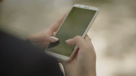 Cropped-shot-of-woman-using-mobile-phone