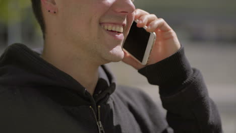 Cropped-shot-of-happy-man-talking-by-mobile-phone