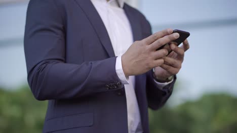 Cropped-shot-of-businessman-using-smartphone