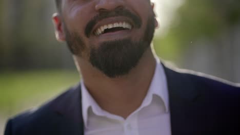 Cropped-shot-of-bearded-businessman-laughing-outdoor