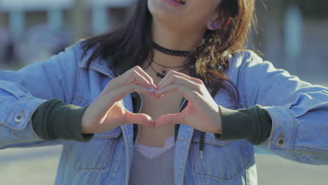 Closeup-shot-of-teen-girl-making-heart-shape-with-hands