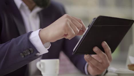 Cropped-shot-of-businessman-using-digital-tablet