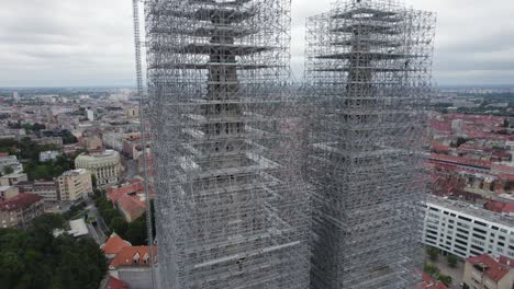 Cathedral-of-Zagreb:-Towers-under-renovation,-enveloped-in-scaffolding---Aerial-Orbit