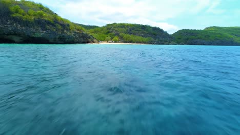 Drone-flies-quickly-over-crystal-clear-Caribbean-waters-of-San-Juan-Curacao-to-the-beach
