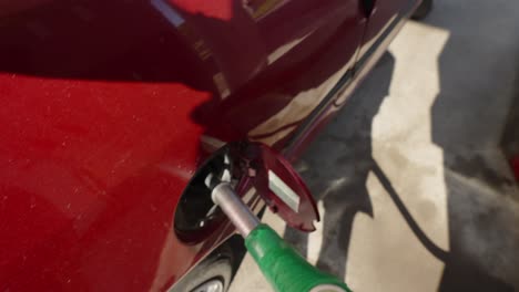 Point-of-view-shot-of-a-person-filling-up-a-fuel-tank-at-a-petrol-station