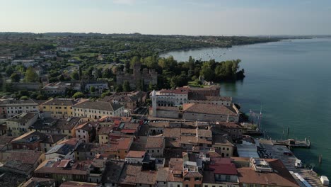 Aerial-shot-of-Italian-villa-with-stone-homes-and-castle-on-the-water