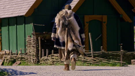 Cinematic-footage-of-a-fur-wearing-viking-in-a-viking-village,-Norway,-Europe