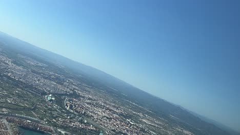 Panoramic-view-of-Valencia-city,-Spain,-during-the-final-left-turn-to-the-airport’s-runway-30-to-land