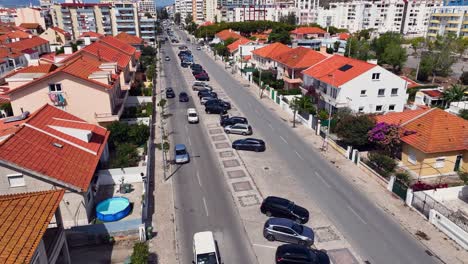 Drone-shot-tilting-down-and-parallexing-over-some-traffic-on-a-dual-lane-avenida
