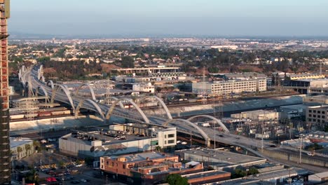 An-aerial-reveal-shot-of-the-6th-Street-Bridge-in-the-arts-district-of-downtown-Los-Angeles