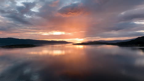 Aerial-hyperlapse-over-vast-Malangen-fjord-with-brilliant-vivid-sunset-sky