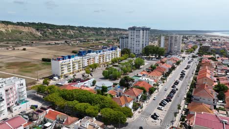 Drone-shot-from-Costa-Da-Caparica,-facing-the-towers-and-hills-inland