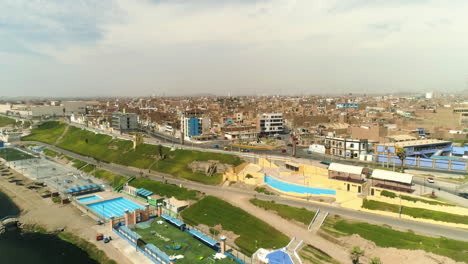 Aerial-view-around-pools-and-a-skate-park-on-the-coast-of-sunny-Huacho,-Peru