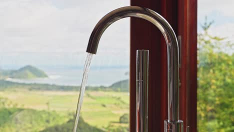 Luxury-tap-ware-in-hotel-bathroom-with-ocean-views-in-the-background
