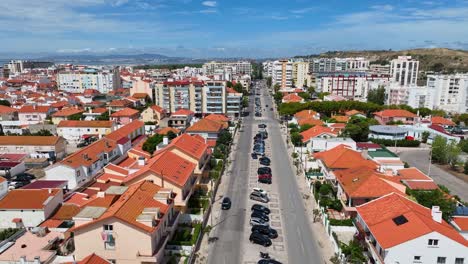 Drone-shot-rising-over-Avenida-Dom-Sebastiao-in-Costa-da-caparica,-portugal
