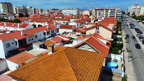 Drone-shot-ascending-and-tilting-down-over-the-roofs-of-townhouses-in-Costa-Da-Caparica