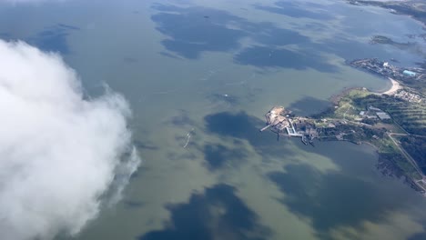 Passenger-POV-from-aircraft-flying-over-the-coastline-near-Montevideo-Uruguay