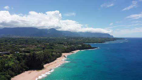 Super-wide-aerial-shot-flying-over-the-beautiful-northern-coastline-of-Kaua'i-at-Princeville-in-Hawai'i