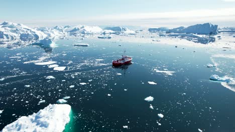 Amazing-aerial-view-of-ship-sailing-in-Icefjord,-Greenland