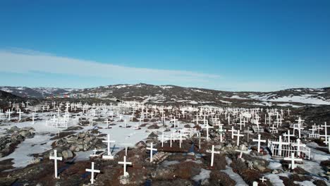 Dramatic-aerial-view-of-white-crosses-in-Ilulissat-Cemetery-on-permafrost-in-Greenland