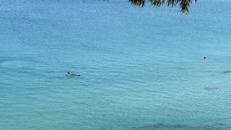 Paddle-boarder-fell-down-in-the-coral-blue-water-of-northern-Cyprus,-close-to-Paphos