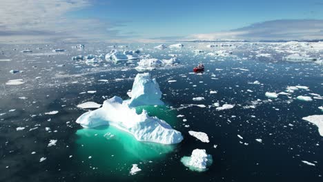 Vessel-sail-in-between-iceberg-near-Greenland-coast,-aerial-view
