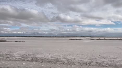 Salt-flat-landscape-from-a-car-window,-in-a-cloudy-sky
