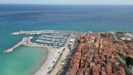 Menton-town-and-beach-on-French-Riviera-pull-back-drone-aerial-reverse-reveal