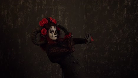 Catrina-Cosplay-girl-moving-slowly,-dancing-with-her-hands-posing-on-her-Right-side-profile-in-Dark-background,-Medium-shot