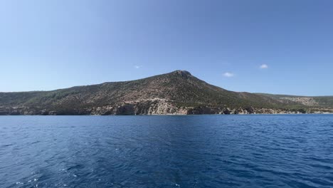 View-from-boat-sailing-in-the-large-blue-sea-near-the-coastline-of-the-long-island-in-Paphos-in-hot-weather