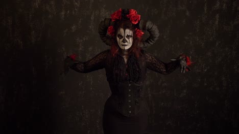 Catrina-Cosplay-girl-moving-slowly-and-opening-her-arms-welcoming-you-in-a-Dark-background,-Medium-shot