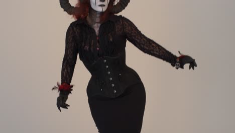 Catrina-Cosplay-girl-tilt-up-while-sensually-moving-with-a-light-background-,-Medium-shot-2