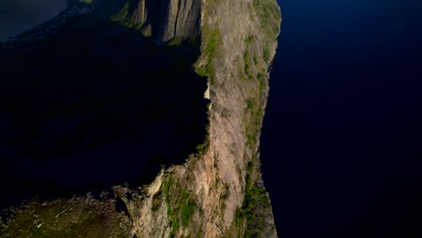 Aerial-birdseye-view-to-a-revealing-shot-of-the-famous-Segla-mountain-on-the-island-of-Senja-Norway-with-the-fjord-and-other-mountains-stretching-back-to-the-horizon