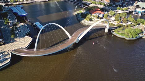 Aerial-Tilt-Up-From-Bridge-Revealing-Elizabeth-Quay-and-Perth-City-Skyline,-Western-Australia