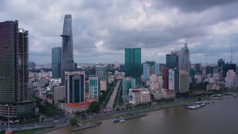 Aerial-city-skyline-daytime-drone-shot-of-Ho-Chi-Minh-City-center,-with-all-key-buildings-and-boats-on-Saigon-river