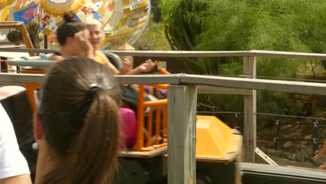 Close-Up-View-Of-Tourists-Riding-Tomahawk-Wooden-Roller-Coaster-In-Port-Aventura-Amusement-Park-In-Salou,-Spain