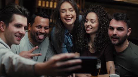 Handheld-video-of-friends-taking-selfie-in-the-pub.